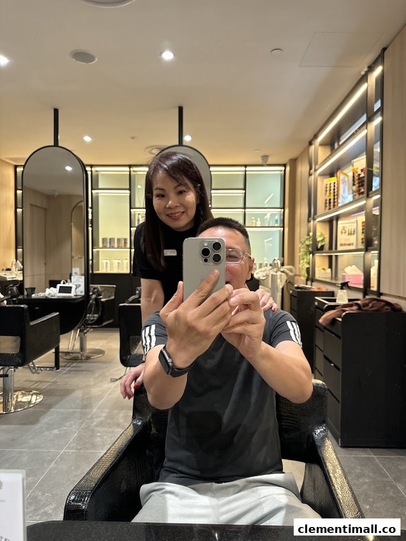 A customer takes a selfie with a friendly staff member inside Jean Yip Hairdressing salon.