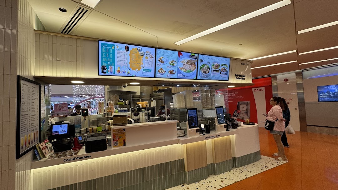 Interior view of Kaffe Toast Thai Noodle Bar's service counter with prominent digital menu boards.