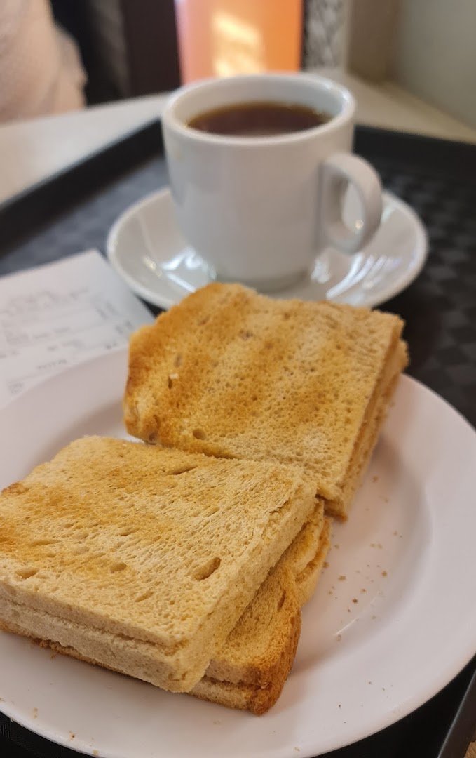 A plate of golden-brown toast served with a comforting cup of hot coffee.