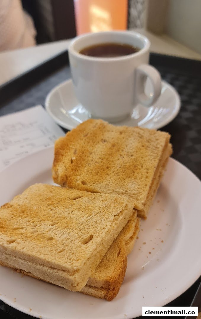 A plate of golden-brown toast served with a comforting cup of hot coffee.