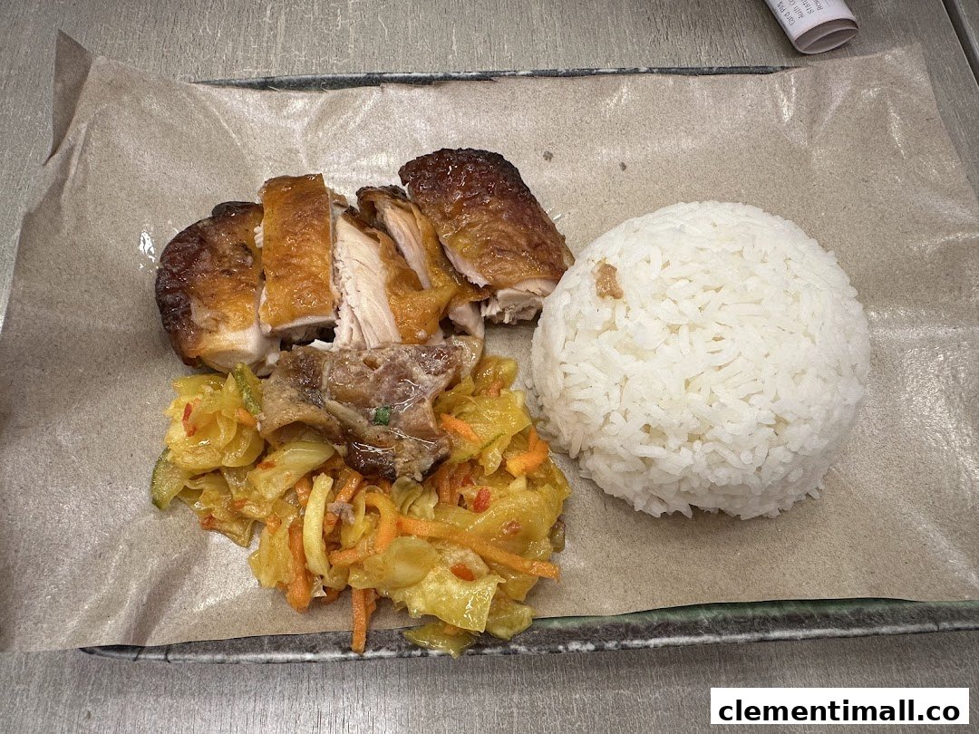 A delicious plate featuring roasted chicken, fluffy rice, and a vibrant side dish.