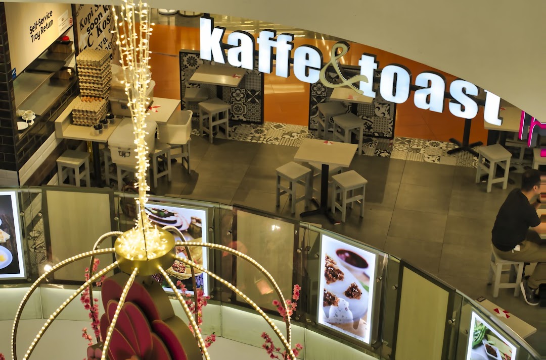 An overhead view of the Kaffe & Toast cafe interior, showing seating, tables, and a self-service area.