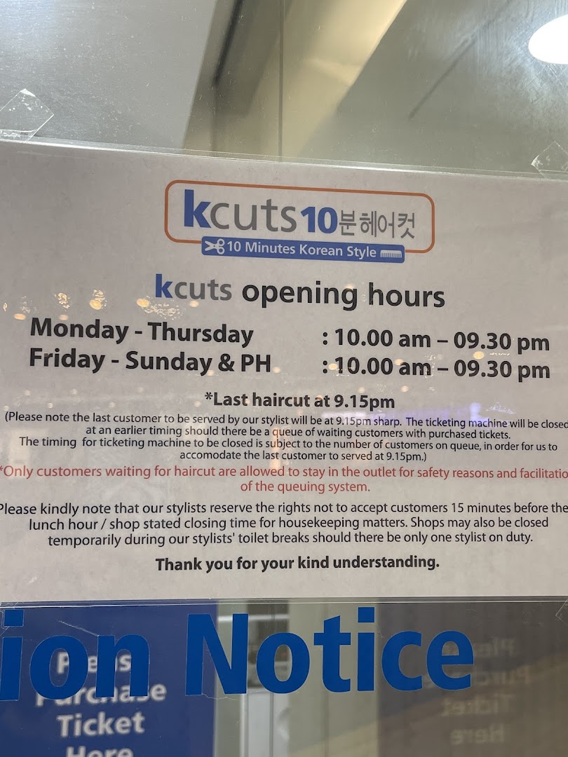 A sign displaying kcuts' opening hours, last haircut timing, and customer policies at the shop entrance.