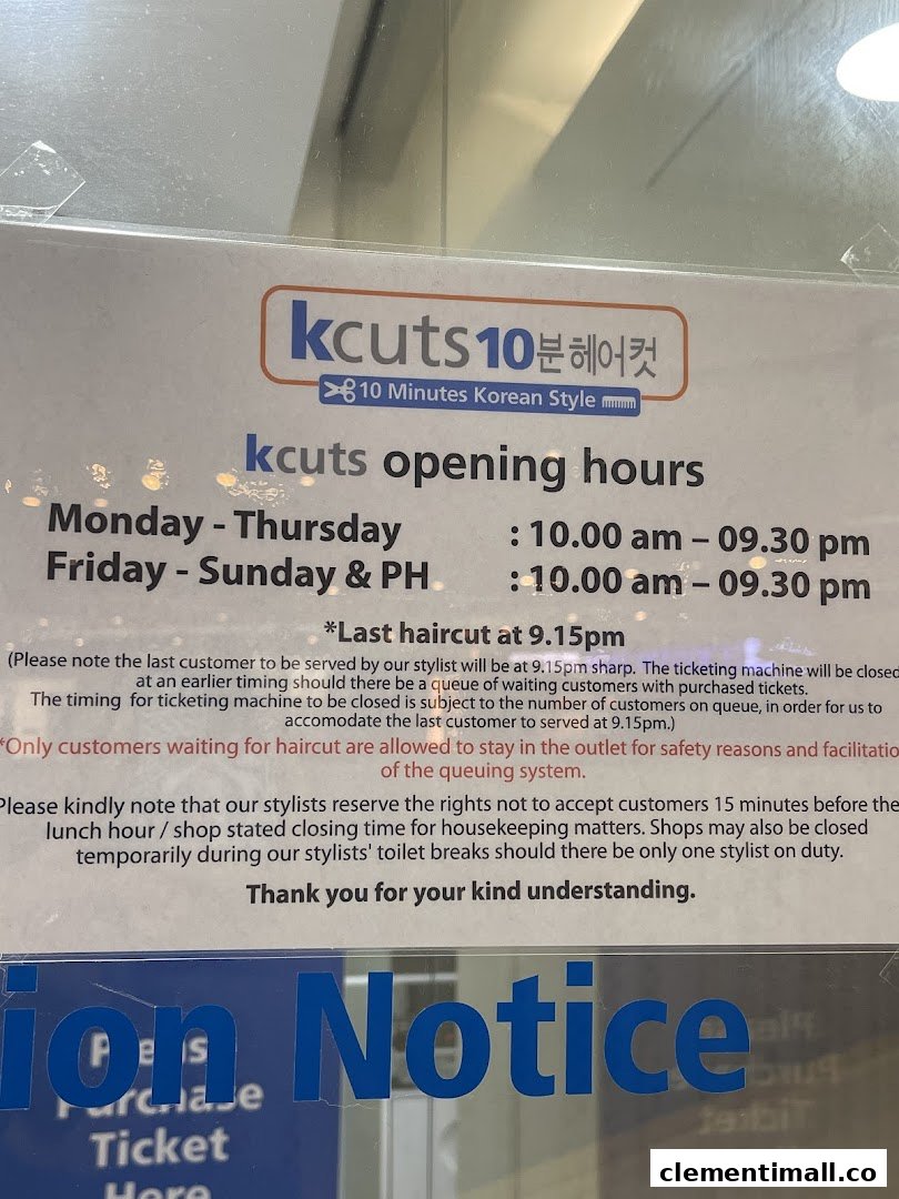 A sign displaying kcuts' opening hours, last haircut timing, and customer policies at the shop entrance.