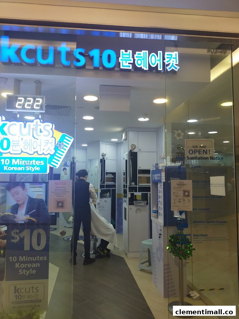 The storefront of kcuts, a hair salon offering 10-minute Korean style haircuts, with a customer inside.