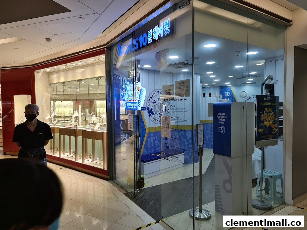 The storefront of kcuts, a Korean-style haircut salon, featuring its entrance and interior view.