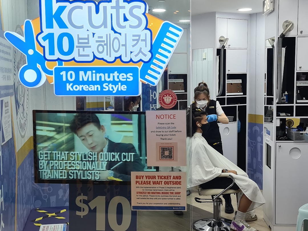 The shopfront of kcuts, a hair salon, featuring its '10 Minutes Korean Style' service and a customer receiving a haircut.