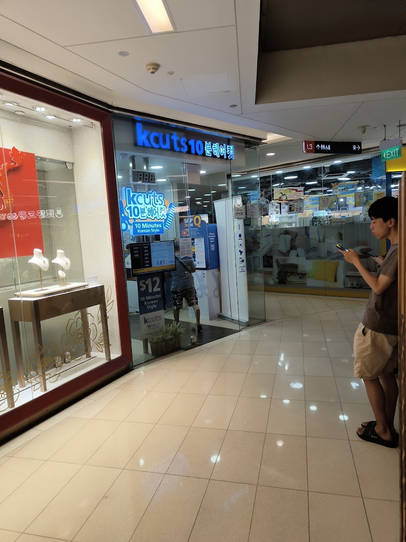 The storefront of kcuts 10-minute Korean style haircut salon at Clementi Mall, featuring its entrance and signage.