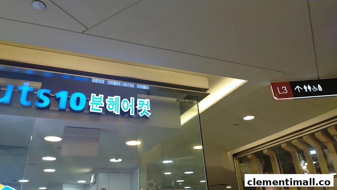 Partial view of kcuts shop front with blue illuminated signage and mall directory sign.