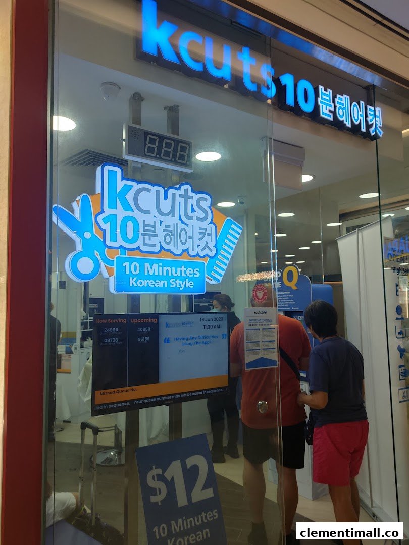 The storefront of kcuts, a hair salon offering 10-minute Korean style cuts, with customers inside.