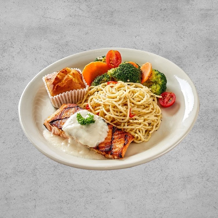 A delicious plate featuring grilled salmon, spaghetti, steamed vegetables, and a muffin.
