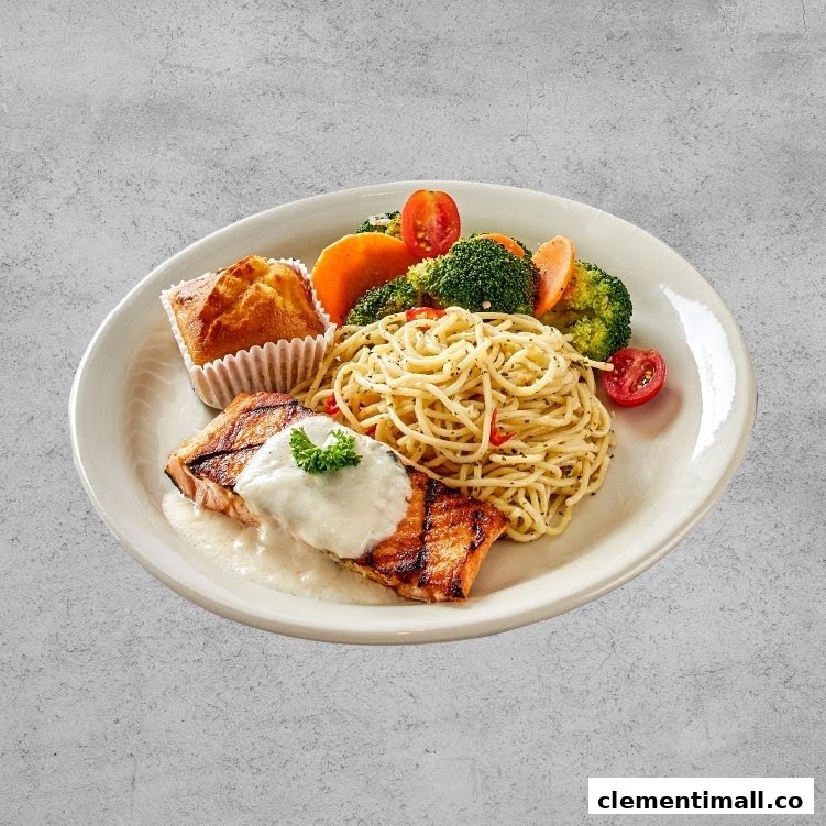 A delicious plate featuring grilled salmon, spaghetti, steamed vegetables, and a muffin.