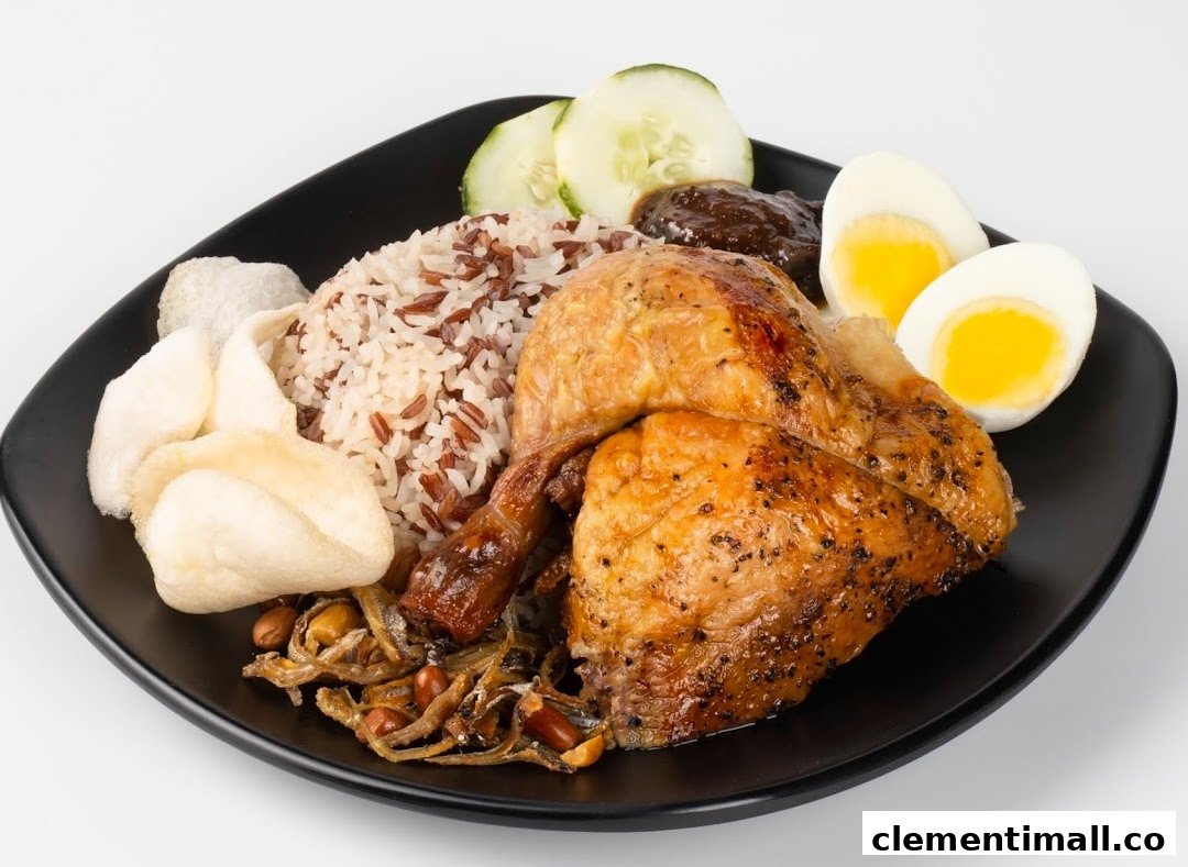 A delicious plate featuring roasted chicken, mixed rice, a boiled egg, cucumber, and crispy crackers.