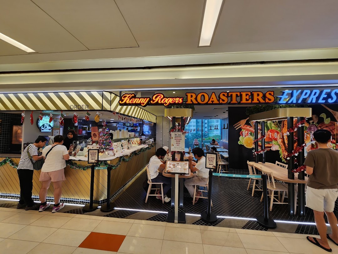 Exterior view of Kenny Rogers Roasters Express, showing the order counter, seating area, and festive decorations.