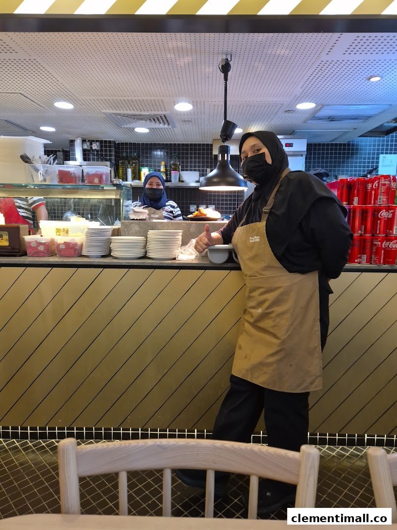 Friendly staff at Kenny Rogers Roasters Express counter, ready to serve with a thumbs-up.