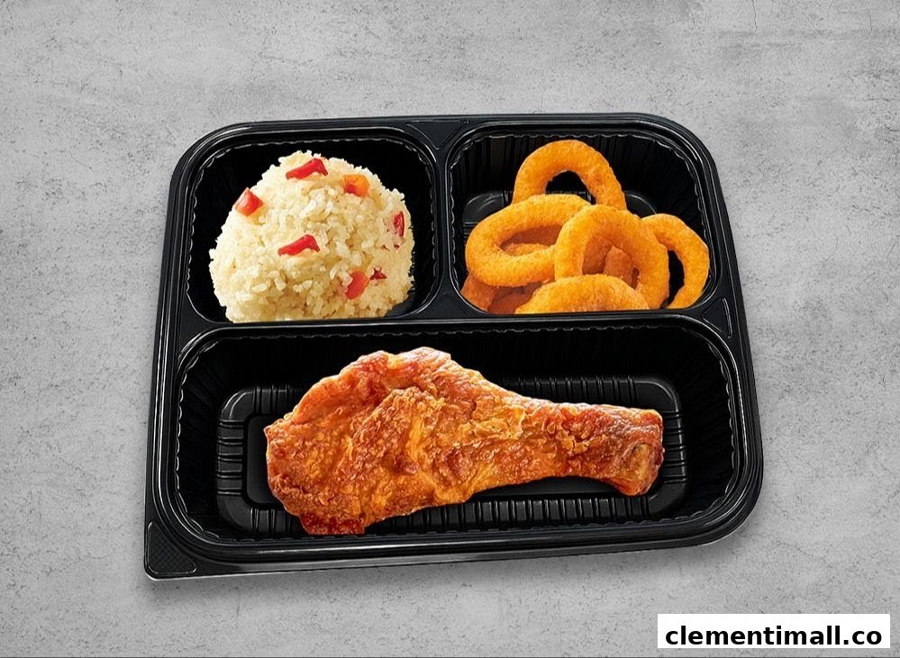 A partitioned meal container featuring fried chicken, rice with peppers, and golden onion rings.