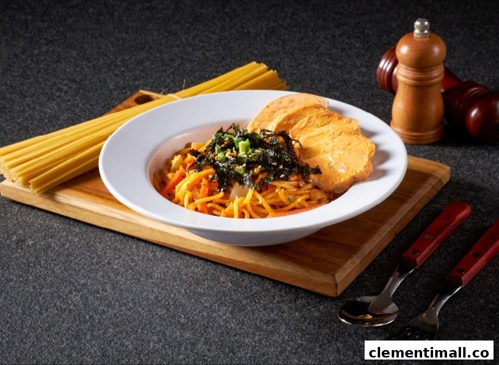 A vibrant pasta dish topped with seaweed and served with bread slices on a wooden board.
