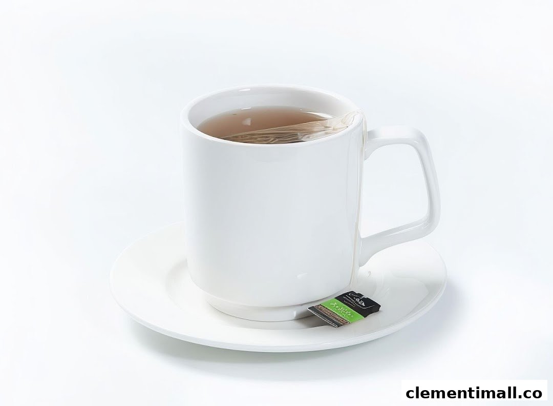 A white mug of hot tea with a tea bag on a saucer, ready to be enjoyed.