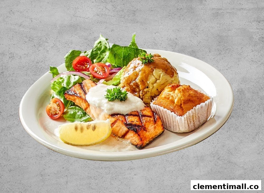A plate featuring grilled salmon, mashed potatoes, a muffin, and a fresh salad.