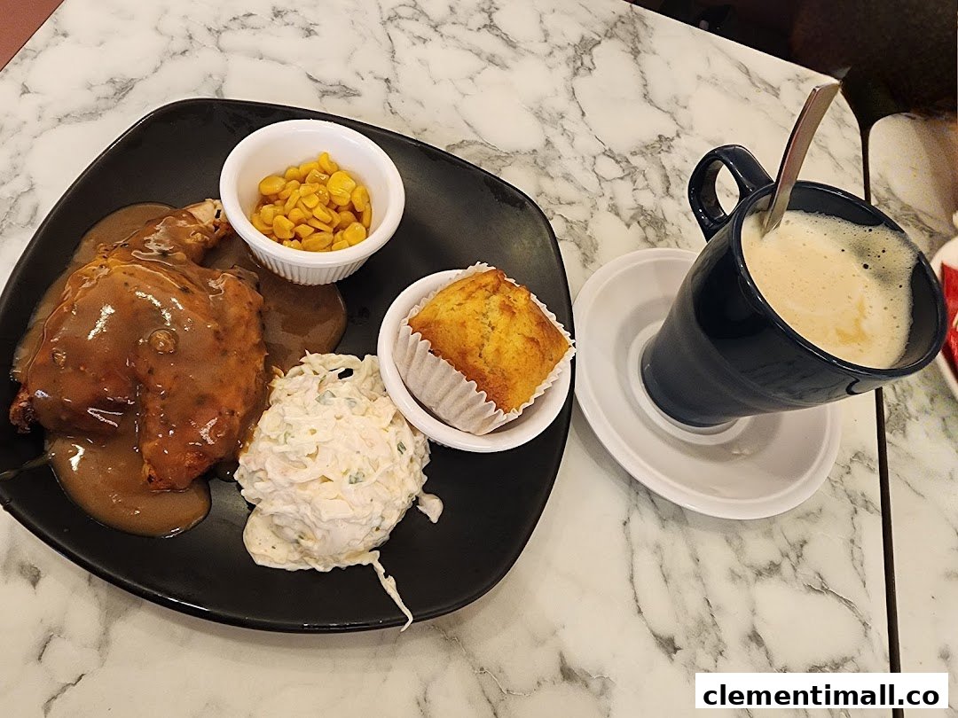 A delicious roasted chicken meal with sides and a hot beverage on a marble table.