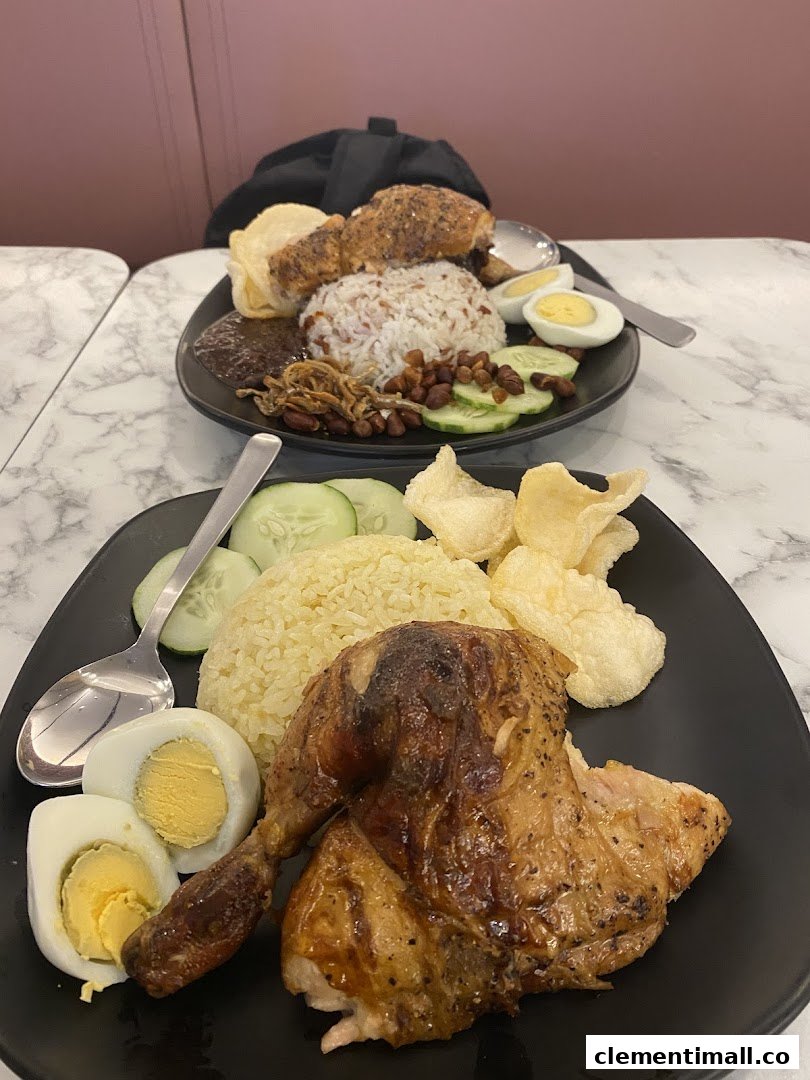 Two plates of delicious roasted chicken meals with rice, eggs, and various sides.