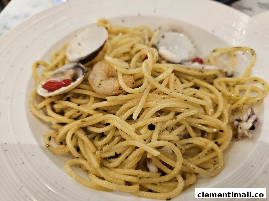 A close-up of a delicious seafood spaghetti dish with clams, shrimp, and squid.