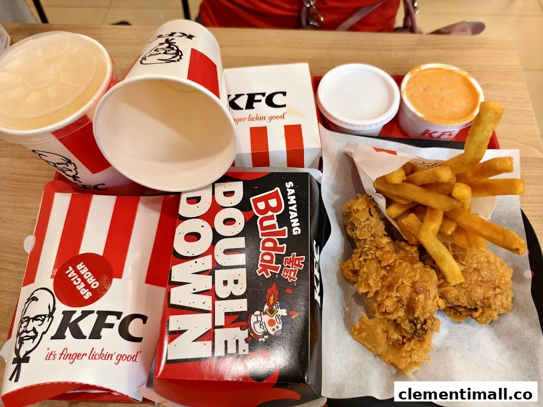 A table filled with a KFC meal, including fried chicken, fries, drinks, and a Double Down.