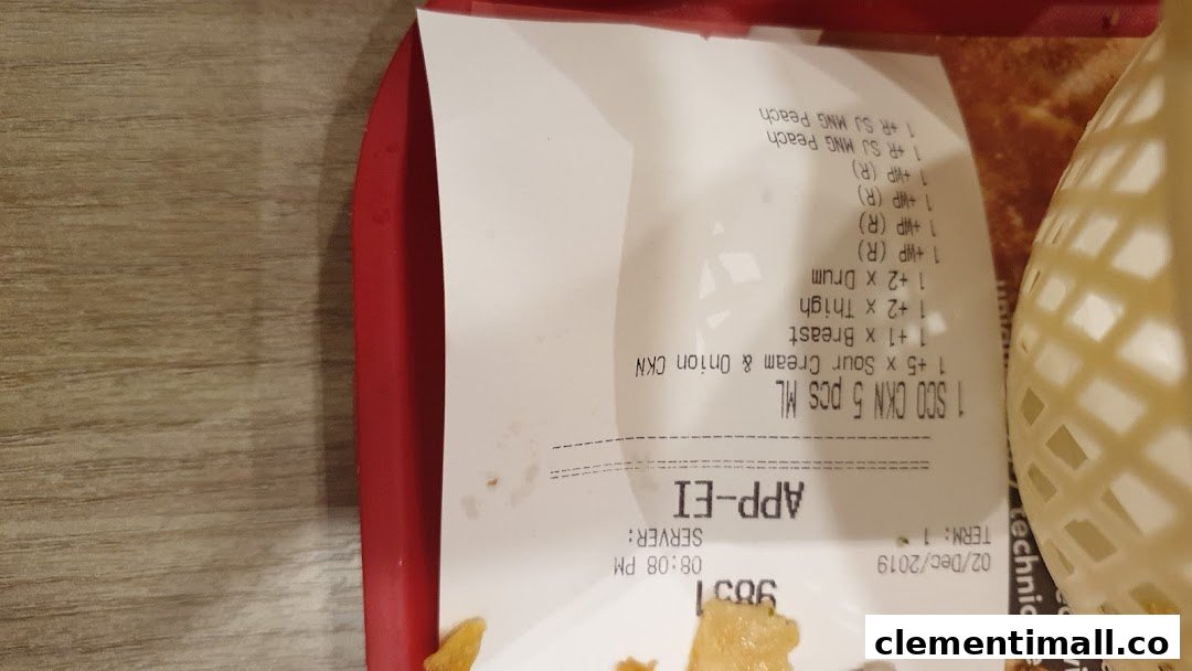 A close-up of a KFC receipt on a red tray, showing purchased items and order details.