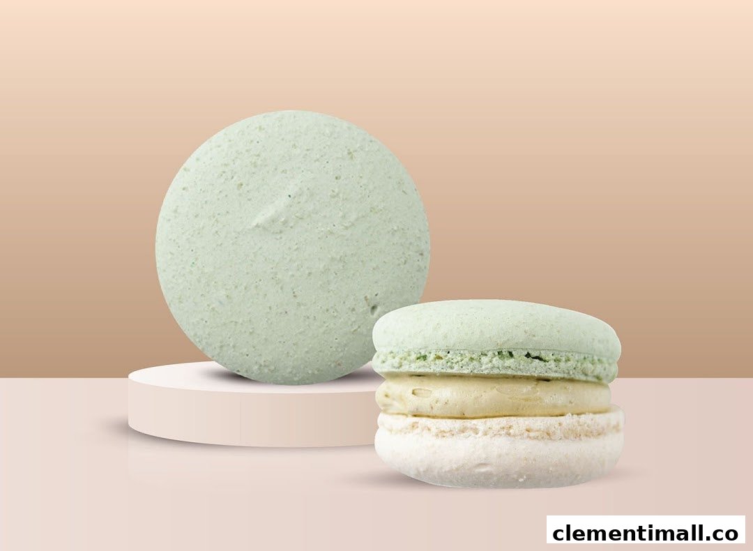 Two light green and white macarons displayed on a minimalist background.