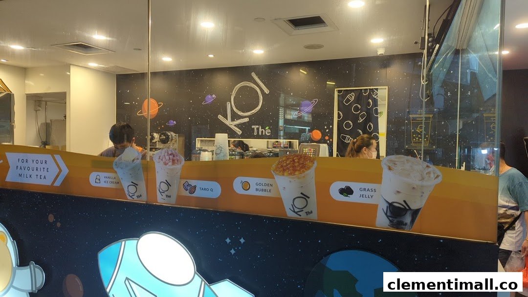 The shop front of KOI Thé, featuring staff, a space-themed interior, and promotional images of popular bubble tea drinks.