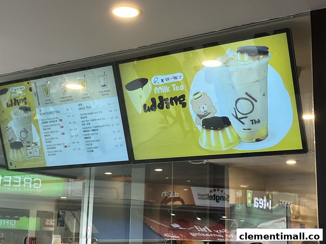 Digital menu boards displaying various bubble tea and milk tea options with prices at KOI Thé.