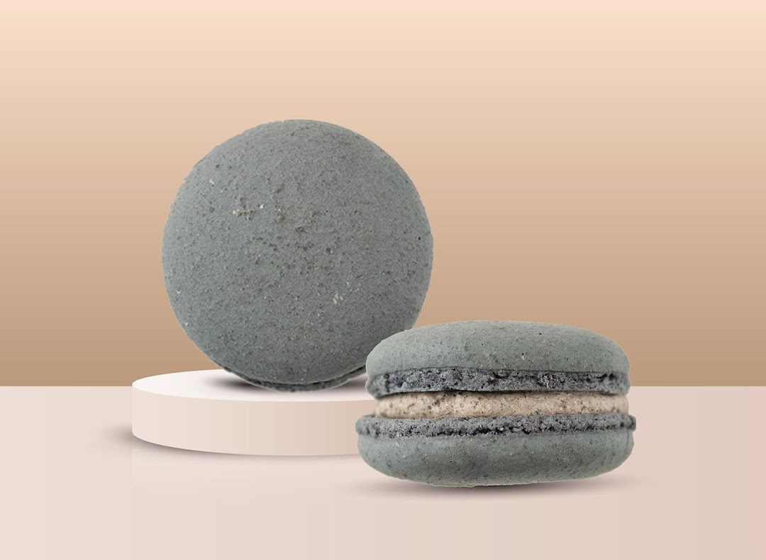 Two grey textured items, one spherical and one macaron-shaped, on a light background.