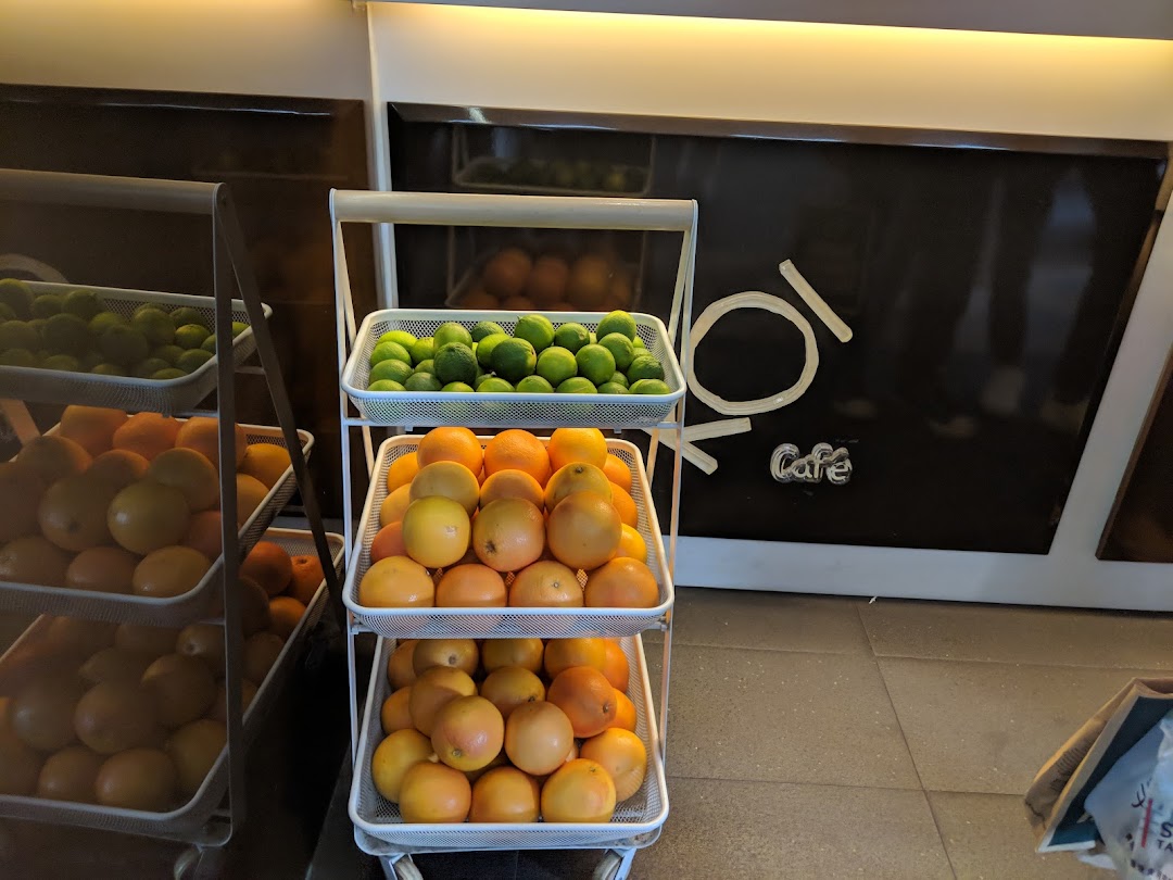Fresh limes and grapefruits displayed on tiered stands inside KOI Thé Cafe, highlighting fresh ingredients.
