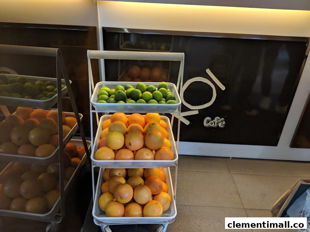 Fresh limes and grapefruits displayed on tiered stands inside KOI Thé Cafe, highlighting fresh ingredients.