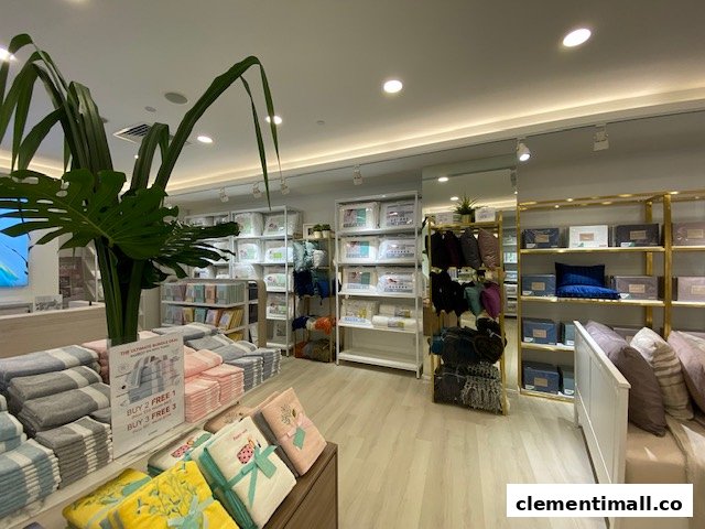 Interior view of KOMME, a home goods store, showcasing bedding, towels, and home essentials with a clean display.