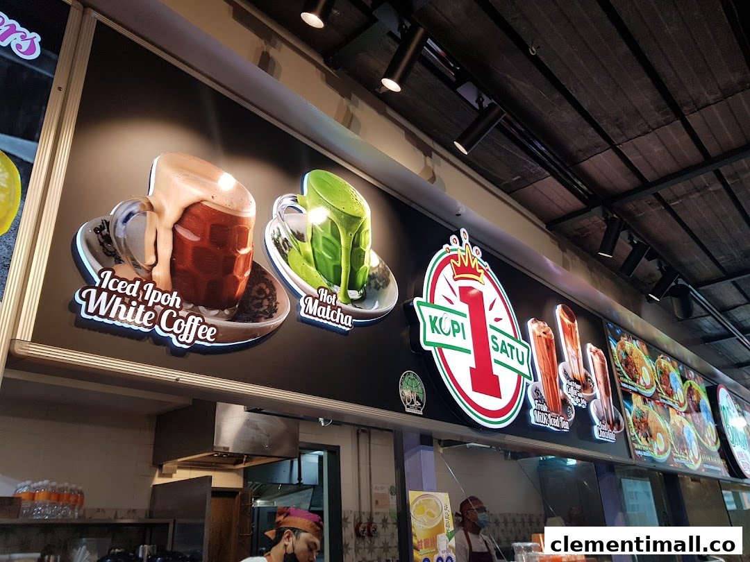 Illuminated signage of Kopi Satu featuring Iced Ipoh White Coffee and Hot Matcha visuals above a service counter.