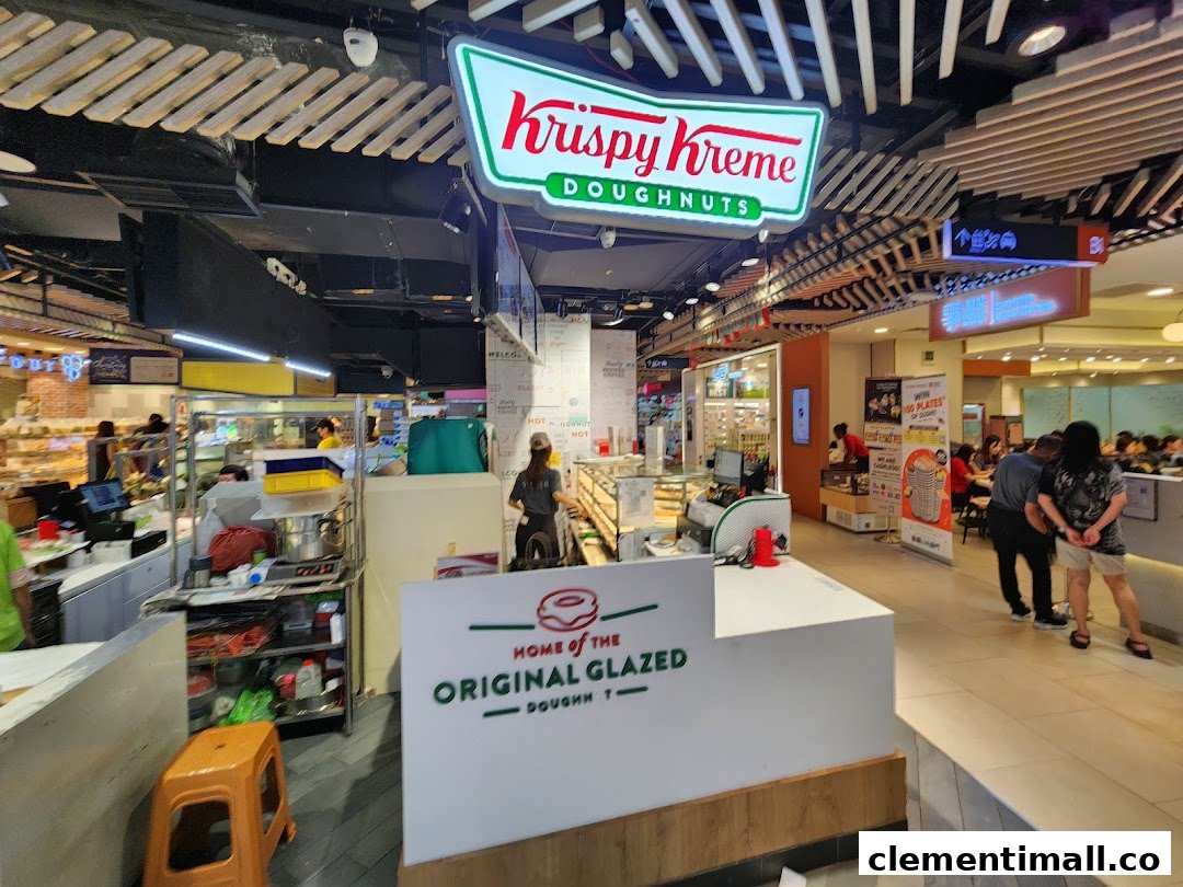 A view of the Krispy Kreme counter and staff, showcasing the doughnut preparation area within the mall.