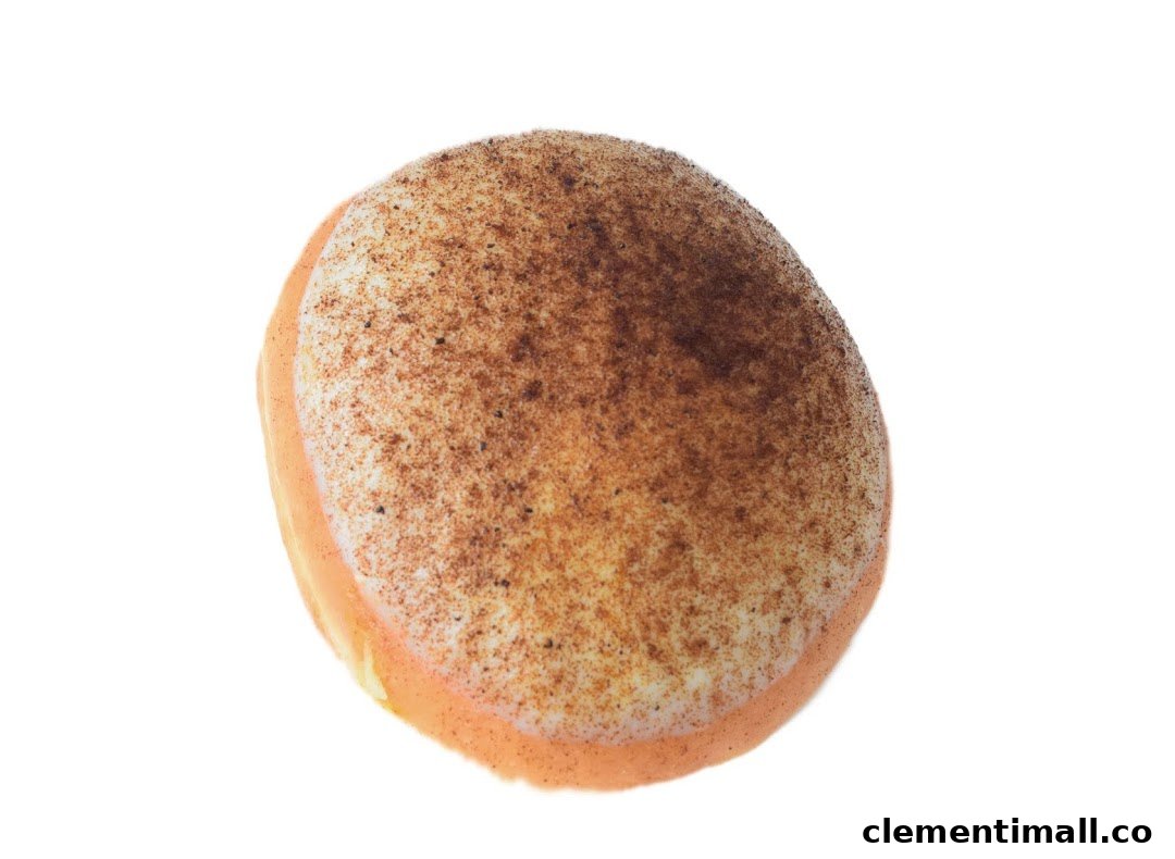 A single Krispy Kreme donut with light orange glaze and cinnamon sugar topping on a white background.