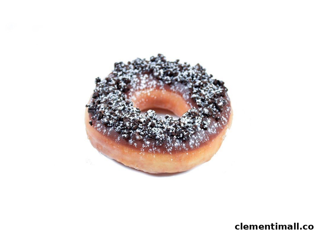 A delicious Krispy Kreme donut topped with chocolate glaze, cookie crumbs, and powdered sugar.