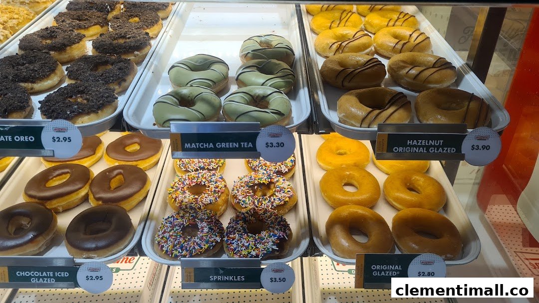A vibrant display case showcasing a variety of Krispy Kreme donuts with different glazes and toppings.
