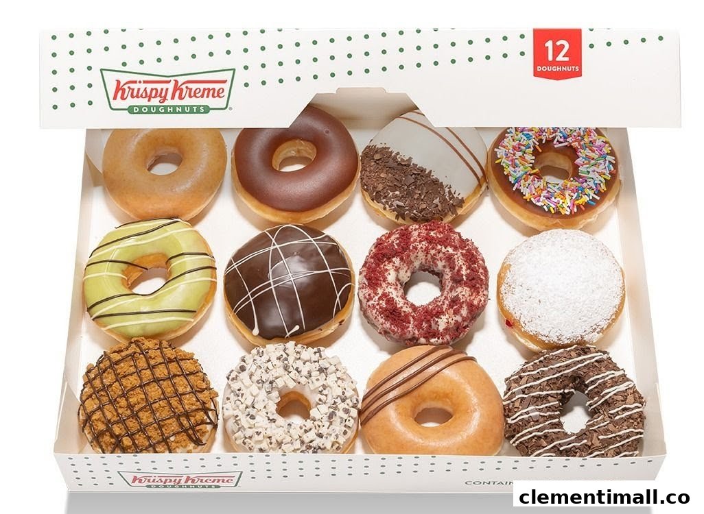 A dozen assorted Krispy Kreme doughnuts in a white box, showcasing various flavors.
