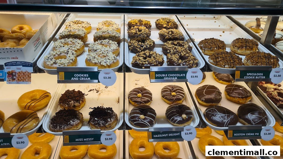 A vibrant display case showcasing a variety of Krispy Kreme donuts with visible prices.