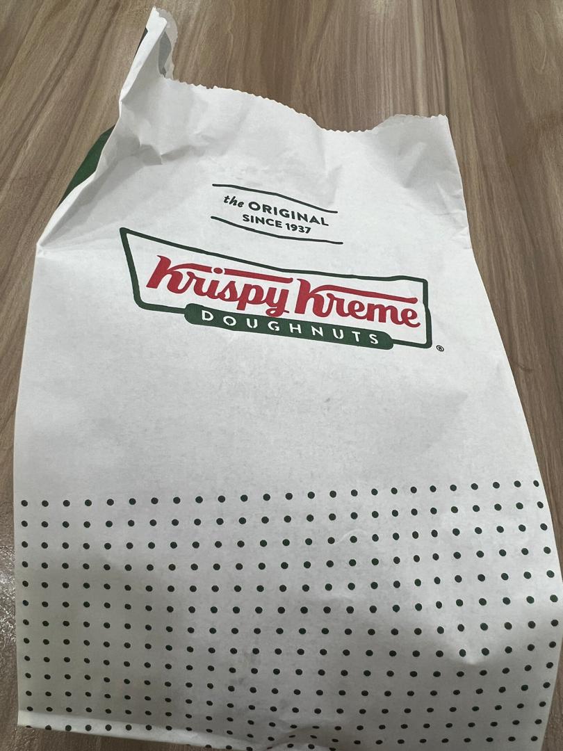 A white Krispy Kreme paper bag featuring the brand logo and 'the ORIGINAL SINCE 1937' text.