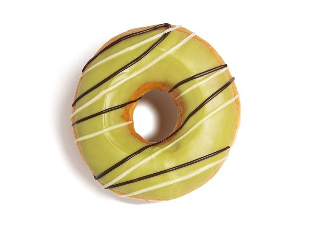 A vibrant green-glazed Krispy Kreme donut with white and dark chocolate drizzles.