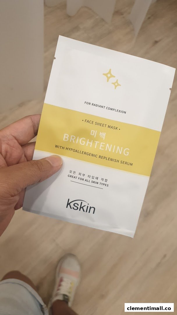 A hand holds a Kskin brightening face sheet mask, designed for radiant complexion.