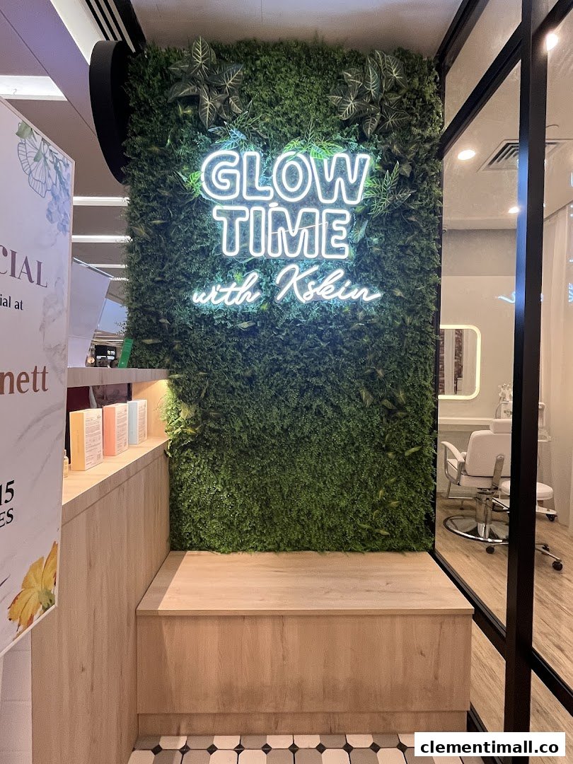 A vibrant green wall with a 'Glow Time with Kskin' neon sign and a wooden bench inside the facial shop.