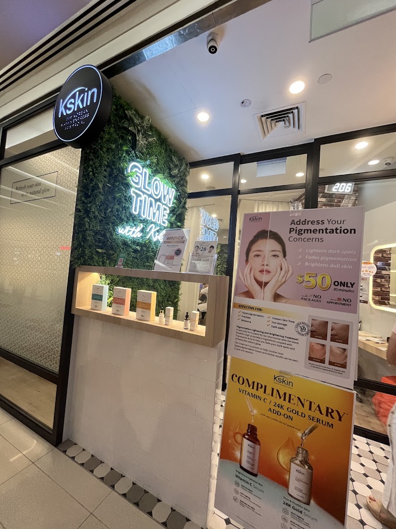 The inviting shop front of Kskin Korean Express Facial, featuring a green wall and promotional displays.