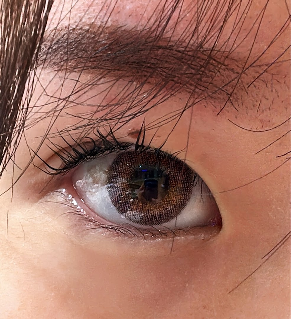 Close-up of an eye showcasing a brown colored contact lens.