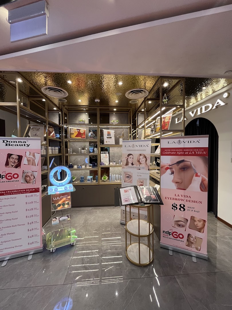 Interior of La Vida beauty shop, featuring product displays and promotional banners for beauty treatments.