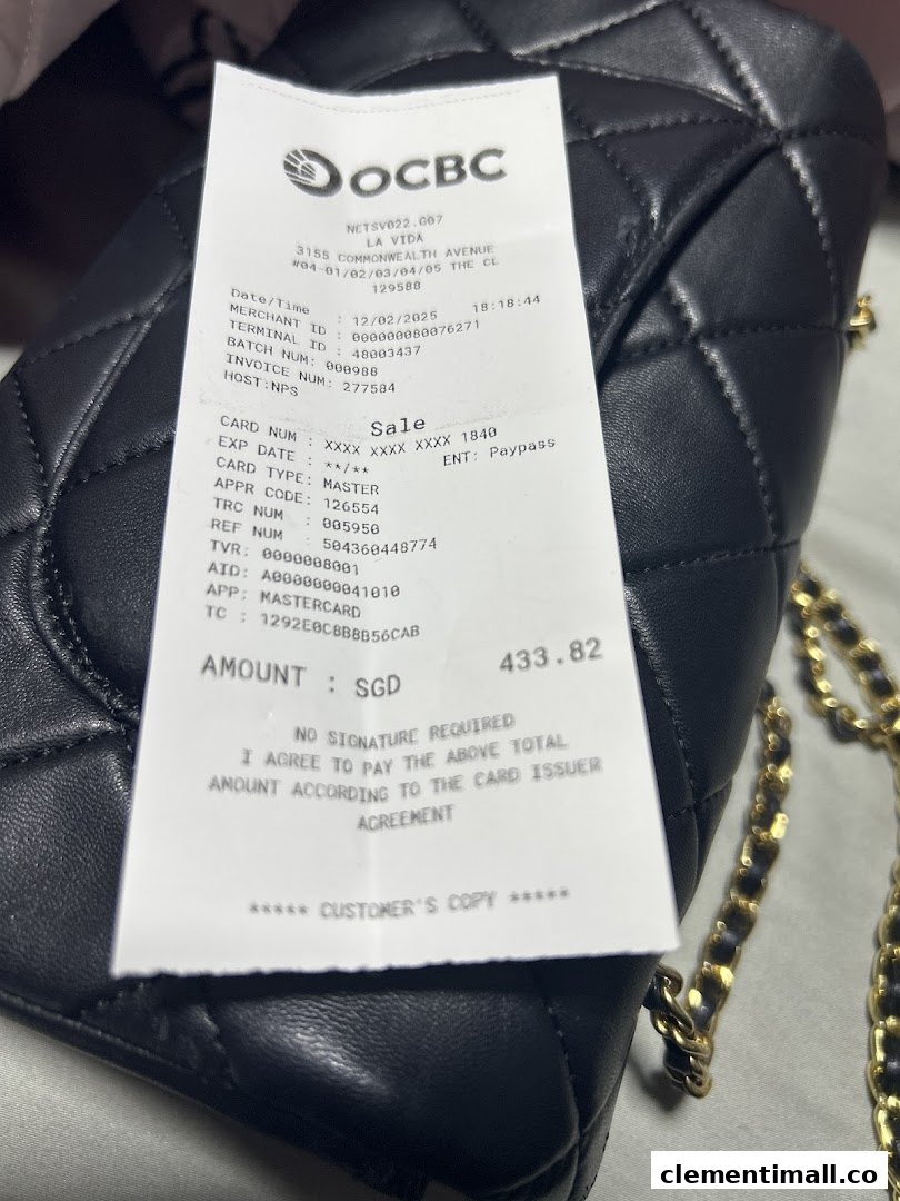 A detailed payment receipt from La Vida displayed on a stylish black quilted handbag.